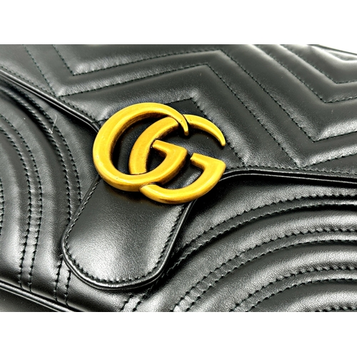 257 - A brand new Gucci GG Marmont flap calfskin black leather handbag featuring a top handle and adjustab... 