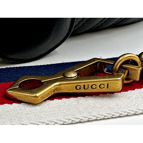 257 - A brand new Gucci GG Marmont flap calfskin black leather handbag featuring a top handle and adjustab... 