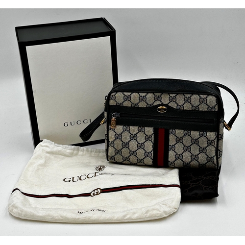 261 - A vintage Gucci monogram GG blue red stripe crossbody bag featuring signature navy Gucci GG print ca... 