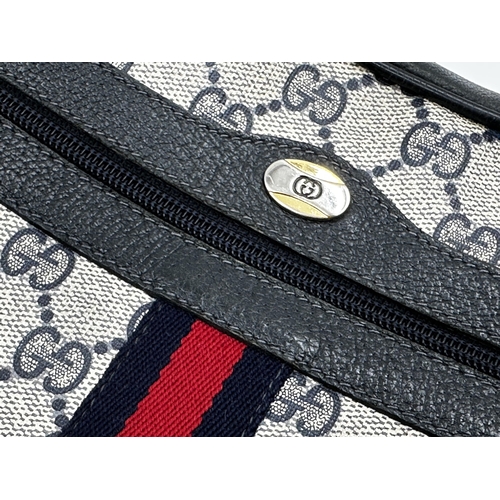 261 - A vintage Gucci monogram GG blue red stripe crossbody bag featuring signature navy Gucci GG print ca... 