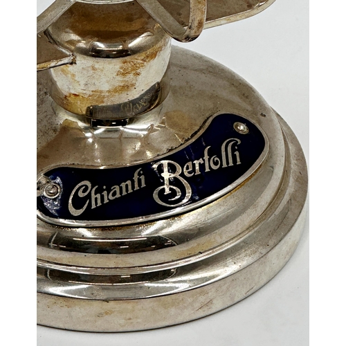 73 - Silver Plated Vintage Tilting Champagne/Wine Cradle. With 'Chianti Bertolli' branding.
h22cm x w19.5... 