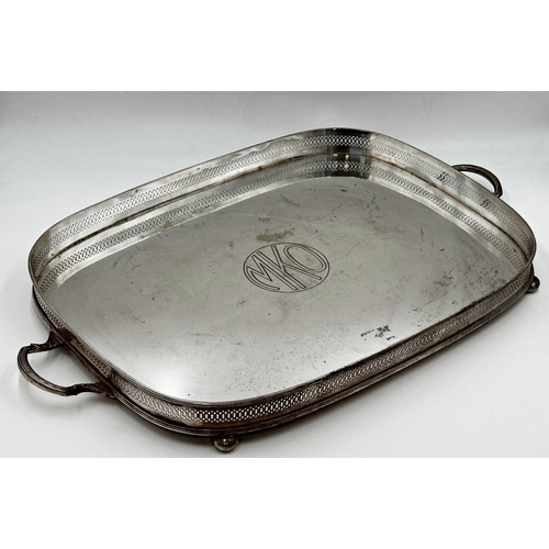 99 - Large silver plate oval tray with pierced gallery sat upon four ball feet with carrying handles. Eng... 