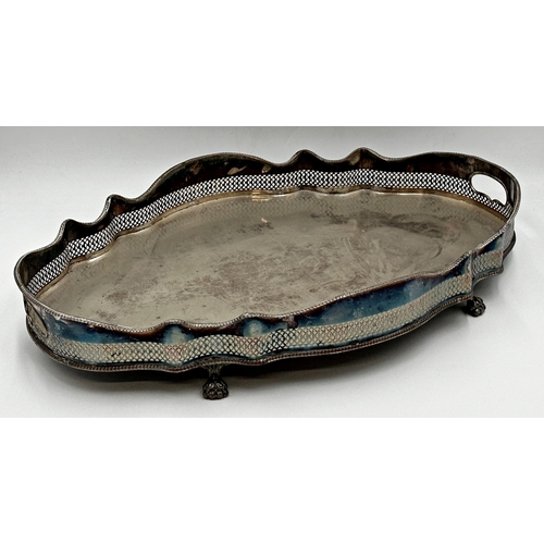 101 - Large silver plated Oval, Serpentine Gallery tray with carrying apertures. Stood upon clawed feet. 
... 