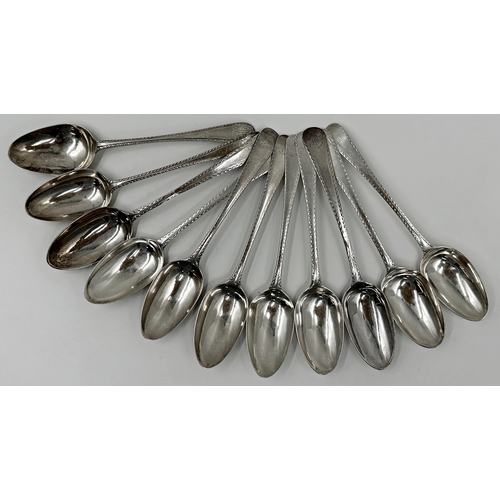 182 - Eleven Georgian and later silver bright cut dessert spoons, 12oz approx