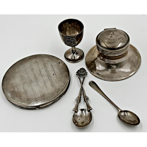 186 - Mixed silver comprising- engine turned compact, capstan inkwell, tea spoon and military egg cup and ... 