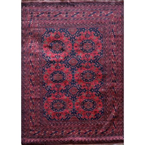 1446 - Good quality Persian fine wool carpet, with geometric medallion decoration on a red ground, 300 x 20... 