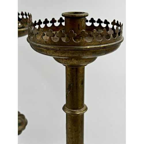 368 - Large pair of ecclesiastical brass gothic candlesticks, with raised club turrets and paw feet, 59cm ... 