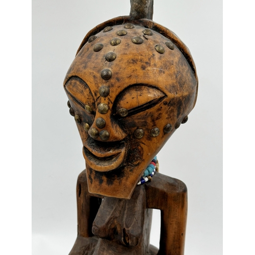 309 - Tribal Interest - Songye power figure from DR Congo, with applied horn and studded decoration, 65cm ... 