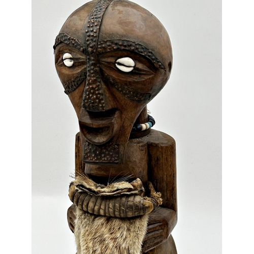 310 - Tribal Interest - Songye power figure from DR Congo, with applied horn and fur pelt decoration, 55cm... 