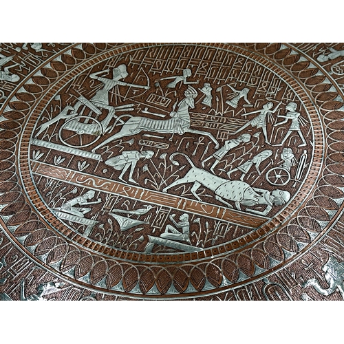 369 - Large copper and silver applied Egyptian charger with various figures and scenes, 65cm diameter.