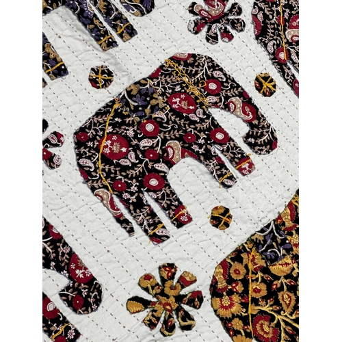 1458 - Indian patchwork cotton bedspread, with geometric elephant pattern and floral borders, 260cm x 210cm... 