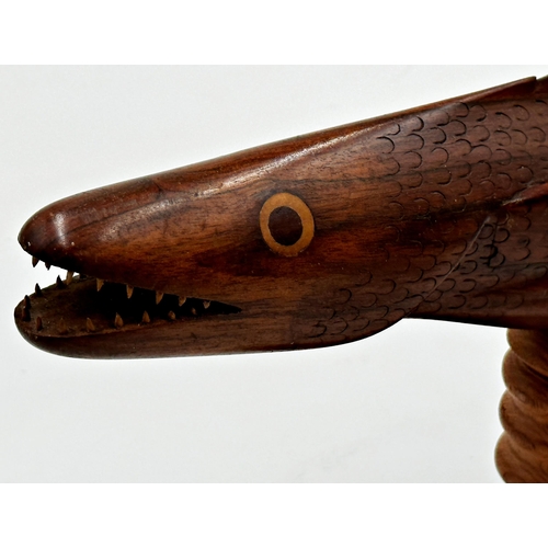 439 - Good carved hardwood model of a flying fish 'Souvenir from Pitcairn Island', upon a turned wooden st... 