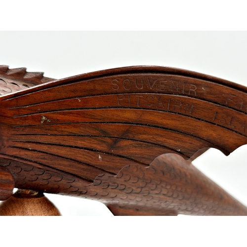 439 - Good carved hardwood model of a flying fish 'Souvenir from Pitcairn Island', upon a turned wooden st... 