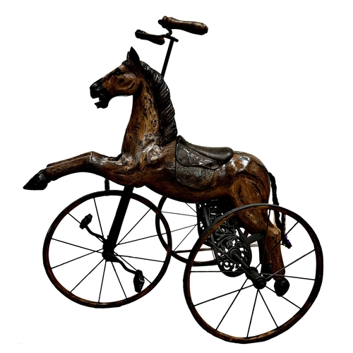 1281 - Carved horse tricycle, with good patina leather saddle and iron wheels and framework, 88cm high.