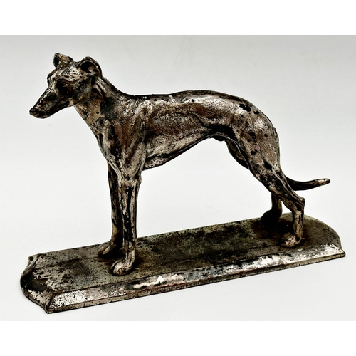 95 - Silver plated figure of a standing greyhound, 15cm x 21cm.