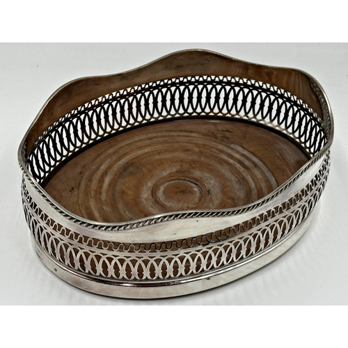 96 - Large oval silver plated wine coaster of baluster form with pierced bowl and turned wooden base, 9cm... 