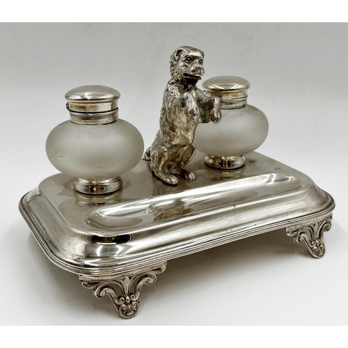 112 - Good quality silver plated novelty desk standish centrally fitted with a cast hound stood on its hin... 