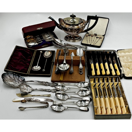 128 - A mixed lot of silver plate items to include cased cutlery sets, a teapot and cased set of enamel co... 