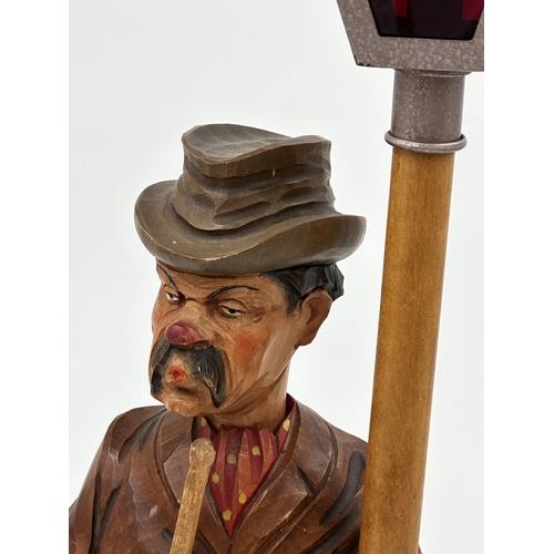 43 - Karl Griesbaum carved wooden whistler or whistling man automaton, under a street lantern, 50cm high,... 