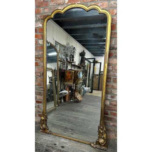 1181 - A 19th century Florentine giltwood full length mirror, with shaped original glass plate flanked by s... 