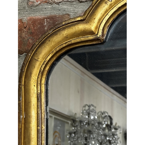 1181 - A 19th century Florentine giltwood full length mirror, with shaped original glass plate flanked by s... 