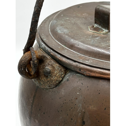 375 - Antique copper lidded cauldron with wrought iron hinged handle, 34cm high