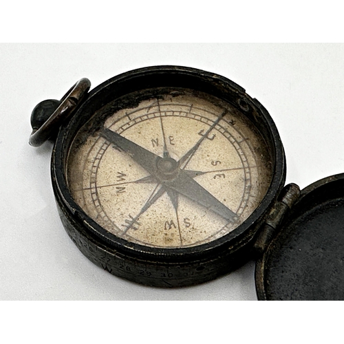 290 - Military pocket compass with hinged lid in working order, 5cm diameter together with a further white... 