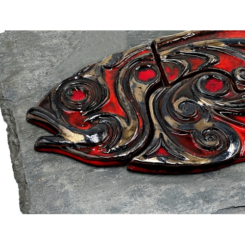 1274 - Jersey Pottery studio pottery wall plaque, red glazed fish on a slate base, 30 x 61cm