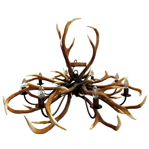 1142 - Impressive pair of simulated entwined antler chandeliers, enclosing an eight branch brass light fitt... 