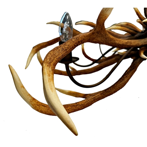 1142 - Impressive pair of simulated entwined antler chandeliers, enclosing an eight branch brass light fitt... 