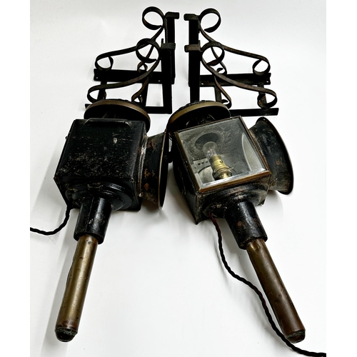 1153 - Pair of 19th century carriage lamps with scrolled wrought iron brackets, each 43cm high, converted t... 