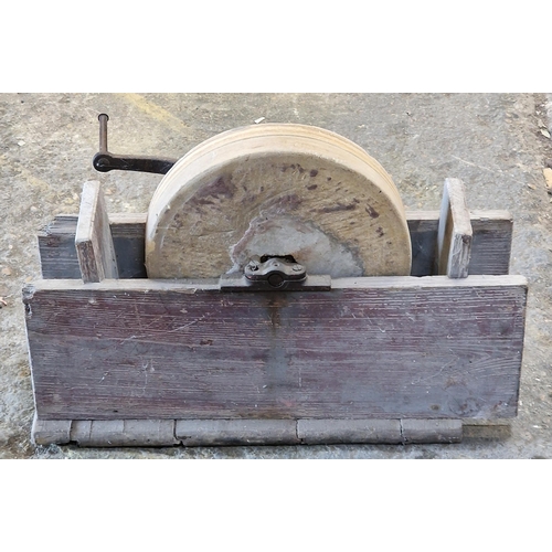 1049 - Vintage grinding wheel with iron handle set in a wooden frame 43 x 65cm