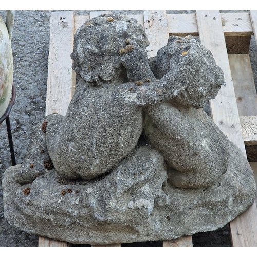 1019 - Antique weathered reconstituted stone garden ornament in the form of cherubs embracing, 50cm high