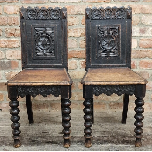 1294 - Pair of antique oak gothic hall chairs or back stools, the raised backs carved with flowerhead and o... 