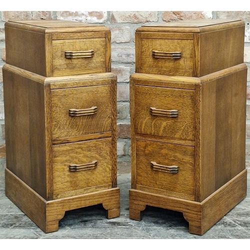 1335 - A pair of Art Deco golden oak bedside cabinets each fitted with 3 short drawers, 76 x 30cm (2)