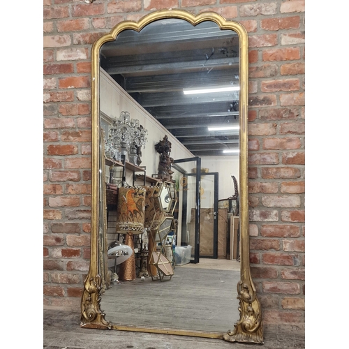 1181 - A 19th century Florentine giltwood full length mirror, with shaped original glass plate flanked by s... 