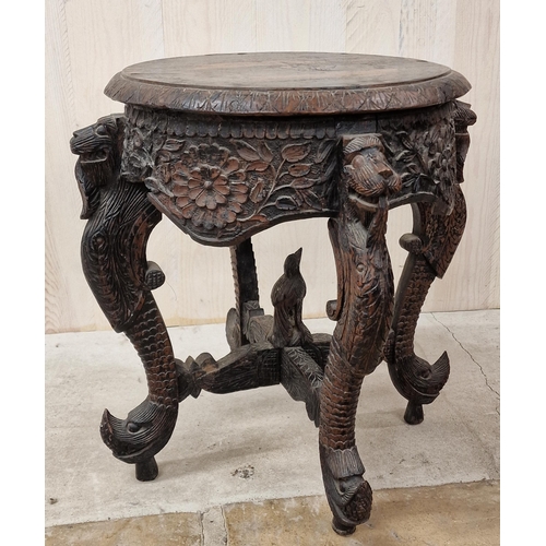 328 - Eastern carved hardwood pot stand or occasional table, the top with darted borders on four mythical ... 