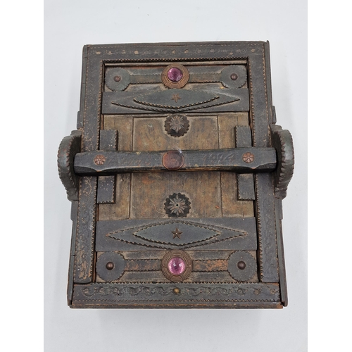 403 - Primitive tramp art box with typical carved detail fitted with two glass cabochons, with slide handl... 