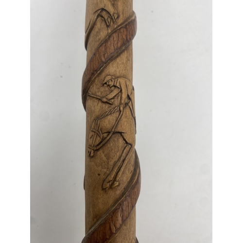 395 - 1930s bespoke hand carved walking stick, a coiled snake trailing up the shaft with panels of various... 