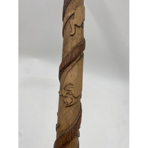 395 - 1930s bespoke hand carved walking stick, a coiled snake trailing up the shaft with panels of various... 