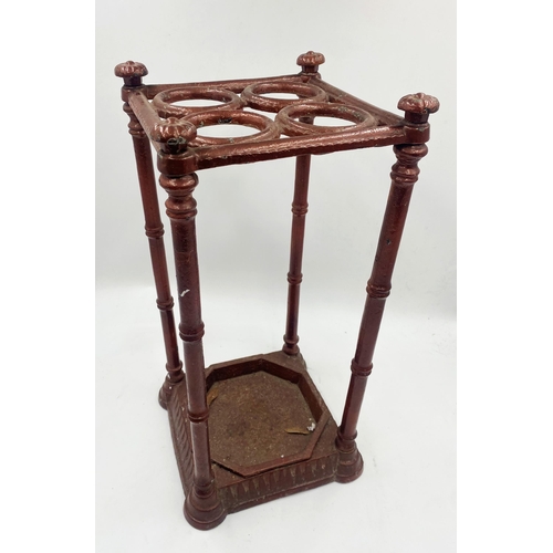 1356 - Victorian cast iron four divisional stick stand, 52cm.