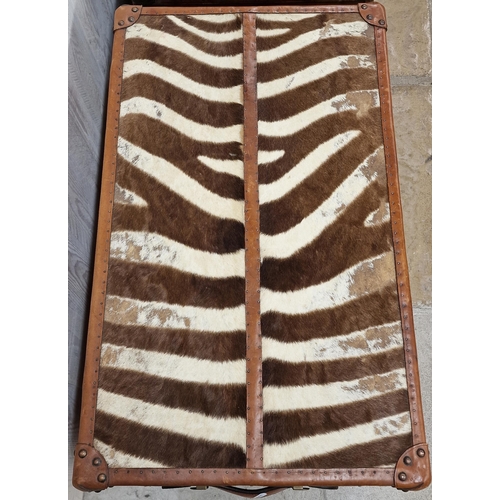 1231 - Pair of good quality reclaimed tan leather and zebra hide trunks, with brass fittings and twin leath... 