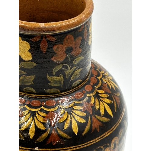 402 - 19th Century Spanish glazed terracotta baluster vase with scrolled floral decoration upon a deep gro... 