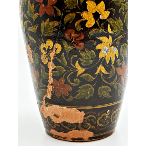 402 - 19th Century Spanish glazed terracotta baluster vase with scrolled floral decoration upon a deep gro... 