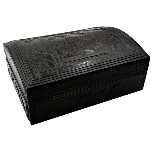 684 - A good quality Indian worked leather dome top casket, with relief top enclosing an interior fitted w... 