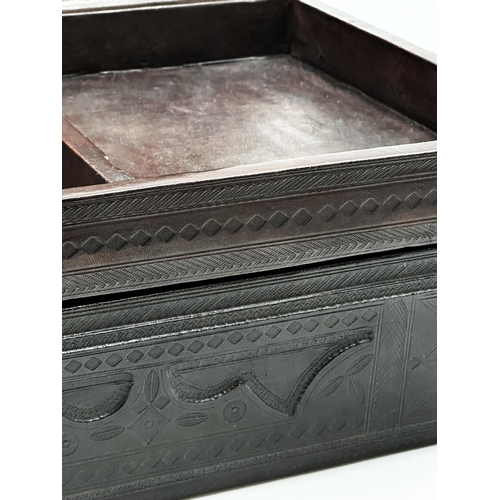 684 - A good quality Indian worked leather dome top casket, with relief top enclosing an interior fitted w... 