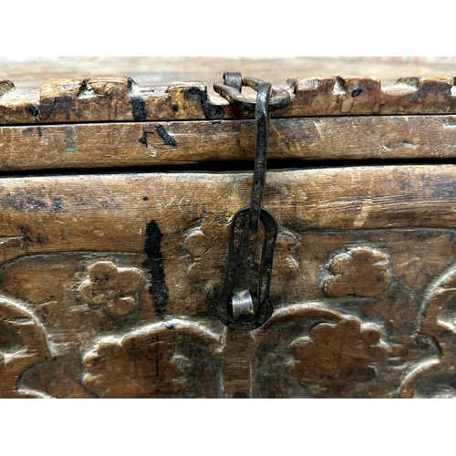 1312 - Antique Pakistani chest with central carved panel and iron strap work fittings, 63 x 92cm