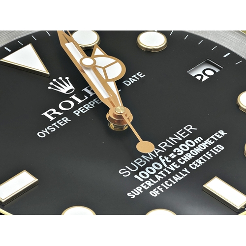 52 - 'Rolex' Submariner novelty wall clock, with black dial and black and gold bezel, sweeping second han... 