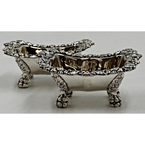 208 - Good pair of William IV cast silver table salts, with scrolled borders, paw feet and gilt interiors,... 