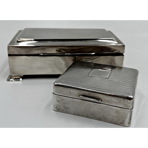 210 - Two silver applied cedar lined cigarette boxes, 17 and 9cm long respectively (2)